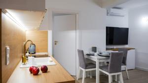 a kitchen and dining room with a table and chairs at Goldfin apartments in Ustka