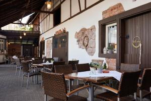 a restaurant with tables and chairs in a room at Gasthaus Blume in Willstätt