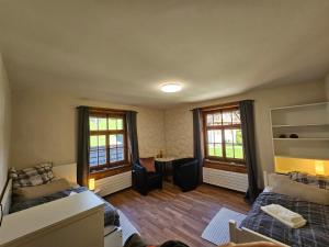 a living room with two beds and a couch at Gästezimmer Ihr Quartier Obergeschoss Zimmer 5 in Gontenschwil