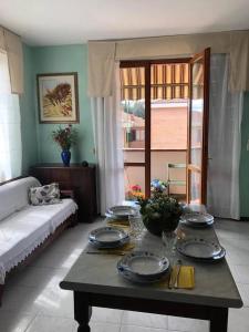 ein Wohnzimmer mit einem Tisch mit Tellern darauf in der Unterkunft 2 bedrooms apartement with city view furnished balcony and wifi at Siena in Siena