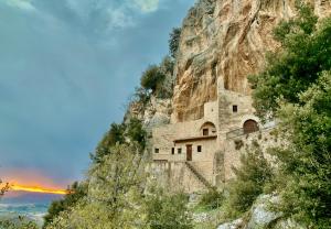 a building on the side of a mountain at A Passo Lento nel Castello di Collepino - Spello in Spello