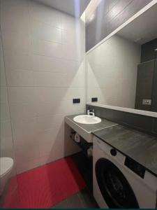 a bathroom with a washing machine and a sink at Beach Pearl in Sutomore +11 photos