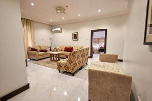 a living room with a couch and a table at MEETHAQ HOTELS MAITAMA in Abuja