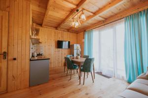 a kitchen and dining room with a table and chairs at Seaside Cottages, BEDO HOUSE in Batumi