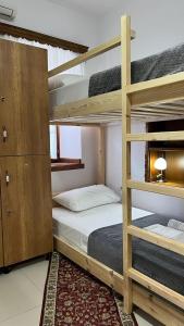 a bedroom with two bunk beds and a bed at Cico Hostel &private room in Gjirokastër