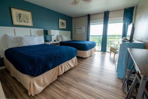 a hotel room with two beds and a television at Ocean Villa Inn in San Diego +37 photos