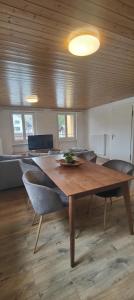 a dining room with a wooden table and chairs at Gästehaus Spring Herznach in Herznach +6 photos