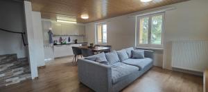 a living room with a couch and a table at Gästehaus Spring Herznach in Herznach