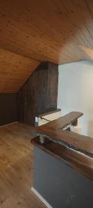 an attic room with a wooden ceiling and a counter at Gästehaus Spring Herznach in Herznach
