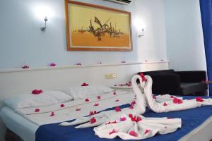 a bedroom with two swans made out of towels at Ares Blue Hotel in Kemer +14 photos