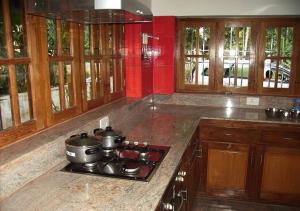 a kitchen with two pots and pans on a stove at 4 Bedroom House@Kottayam TownA/C 812983!5682 in Kottayam