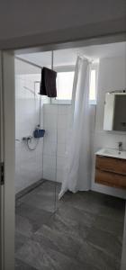a bathroom with a shower and a sink at GrenzApartments in Bietingen