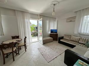 a living room with a couch and a table at Suit Fiona in Fethiye