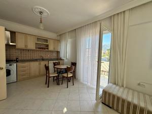 a kitchen and dining room with a table and chairs at Suit Fiona in Fethiye