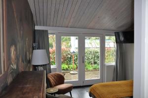 um quarto com uma cama e uma porta de vidro deslizante em B&B Slotstraat em Dreischor