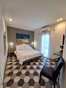 a bedroom with a large bed and a chair at PAVIAN in Levanto