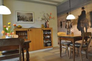 a dining room with a wooden table and a dining room at B&B Slotstraat in Dreischor
