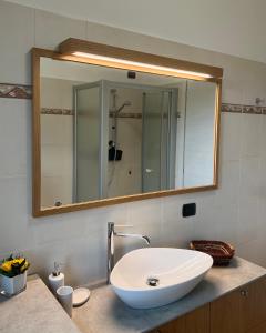 a bathroom with a white sink and a mirror at 2 Cuori al Lago - Appartamento in villetta singola in Mandello del Lario