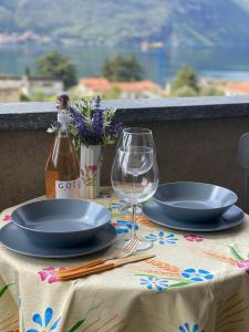 a table with two plates and a wine glass at 2 Cuori al Lago - Appartamento in villetta singola in Mandello del Lario
