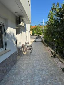 a group of chairs sitting next to a building at Adoniss Apartmentss in Paralia Dionysiou