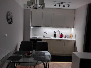 cocina con mesa de cristal y fregadero en Romance Paris B502, en Sveti Vlas