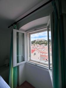 una ventana abierta con vistas a la ciudad en Apartments Tudor Nikola en Hvar