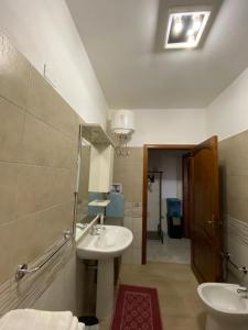 ein Bad mit einem Waschbecken und einem Spiegel in der Unterkunft CASA SANT'ANNA in SantʼAnna Arresi