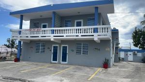 a blue and white house with a balcony at Playa Apartments in Salinas