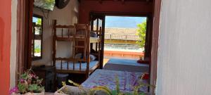a room with a bunk bed and a room with a window at Hotel City of Dreams Antigua in Antigua Guatemala