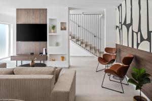 a living room with a couch and chairs at NEW Villa Carmen with 5 en-suite bedrooms, 48 sqm pool, 8km from sea in Tugare