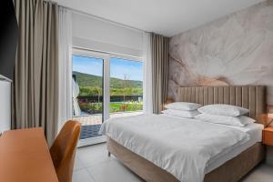 a bedroom with a bed and a large window at NEW Villa Carmen with 5 en-suite bedrooms, 48 sqm pool, 8km from sea in Tugare +56 photos