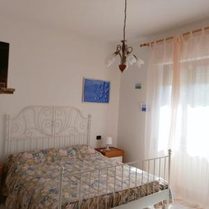 1 dormitorio con cama y ventana en La Collina, en Riccò del Golfo di Spezia