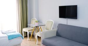 a living room with a couch and a table with chairs at Taksim Next Hotel in Istanbul