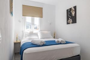 a bedroom with a bed with towels on it at Victoria House in Skopelos Town