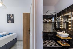 a bathroom with a black tiled wall at House Victoria in Skopelos Town