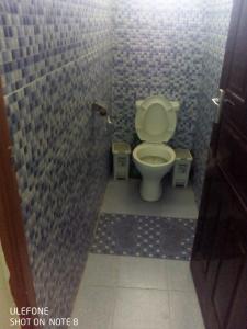 a bathroom with a toilet in a tiled stall at Top tier A 01 in Nakuru