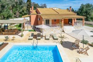 a villa with a swimming pool and a house at Villa Loukiana in Kavos