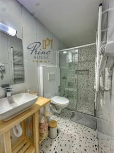 a bathroom with a toilet and a sink and a shower at Princ house in Leskovac