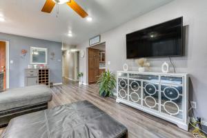 a living room with a flat screen tv on a wall at Newly Remodeled Home in Storm Lake with Private Yard in Storm Lake
