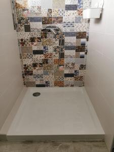 a bathroom with a tiled shower with a sink at A Praia, My Own Paradise- Estúdio in Figueira da Foz