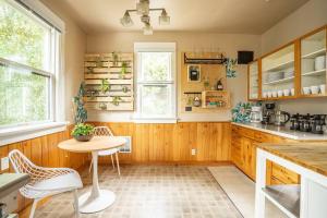 a kitchen with wooden cabinets and a table and chairs at Charming Room in Historic BnB with Parking - Rm 5 in Seattle +17 photos