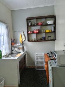 a kitchen with a sink and a microwave at Kai Suite Kitale in Kitale