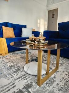 a coffee table in a living room with a blue couch at Kai Suite Kitale in Kitale
