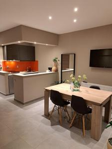 a kitchen with a wooden table and chairs in it at Guest house del Mar in Iraklitsa +9 photos
