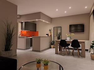 a kitchen with a table and chairs in a room at Guest house del Mar in Iraklitsa