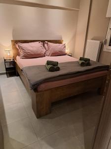 a bedroom with a large bed with two bags on it at Guest house del Mar in Iraklitsa