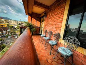 a group of chairs sitting on a balcony at Hotel Castilla Real in Pereira
