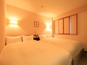 Letto o letti in una camera di Centurion Hotel Hamamatsu