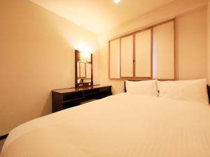 Letto o letti in una camera di Centurion Hotel Hamamatsu