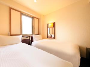 Letto o letti in una camera di Centurion Hotel Hamamatsu